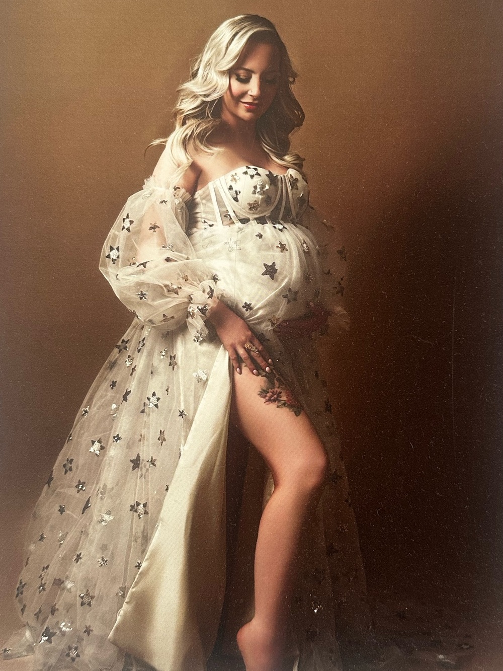 Off-Shoulder Champagne Tulle Gown with Star Embellishments.